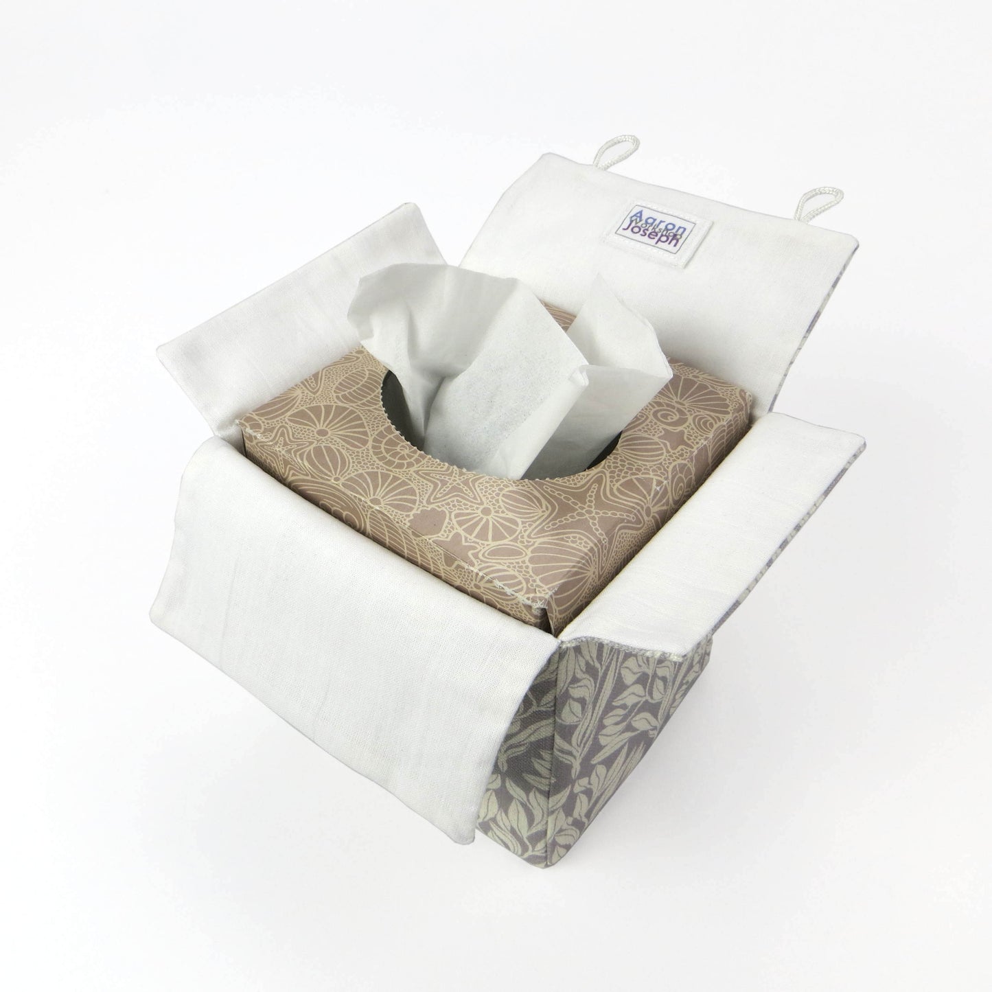 Square linen tissue box cover with off-white leaf design on a light grey background