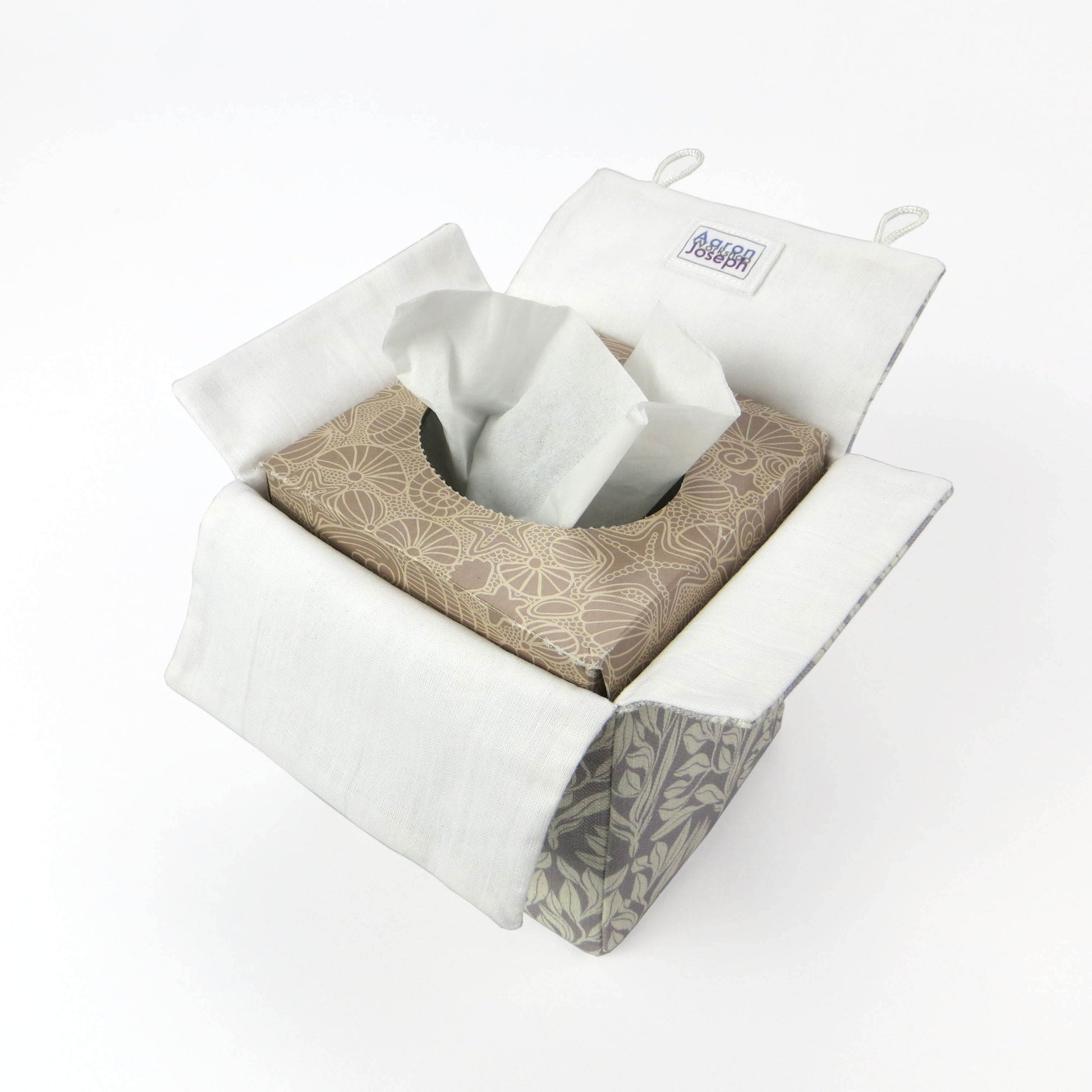 Square linen tissue box cover with off-white leaf design on a light grey background
