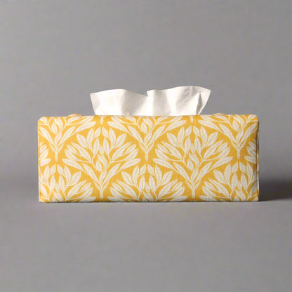 Linen rectangular tissue box cover with an off-white leaf design on a yellow background