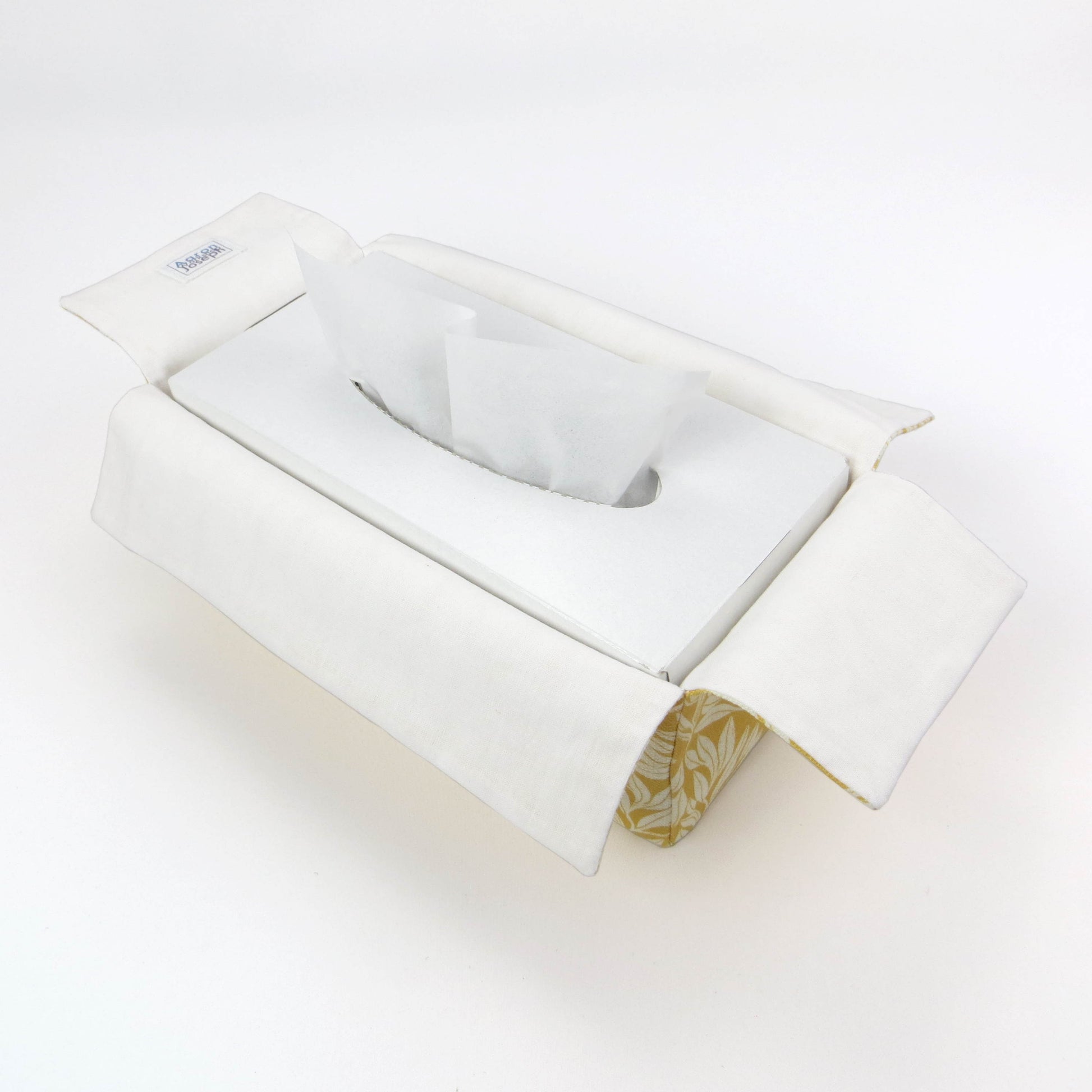 Linen rectangular tissue box cover with an off-white leaf design on a yellow background