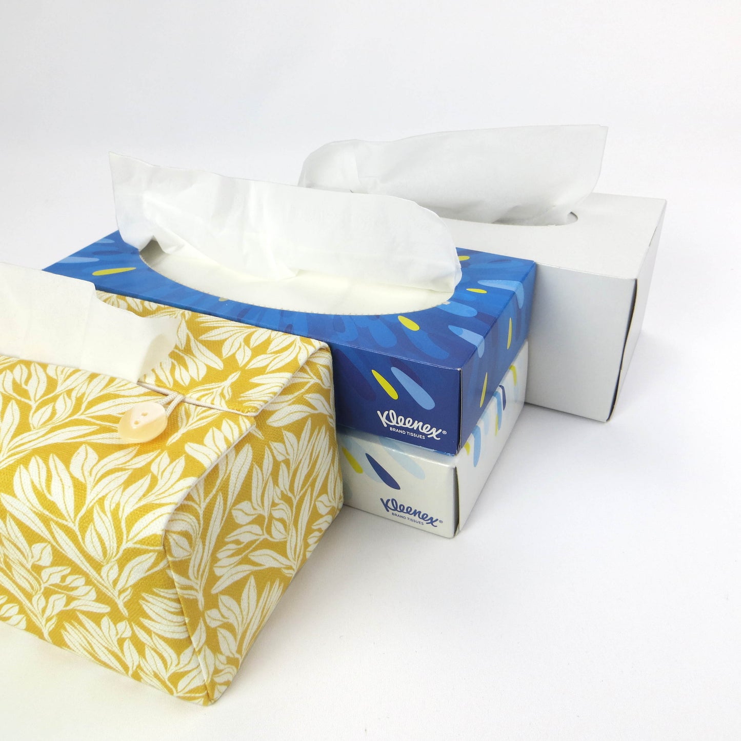 Linen rectangular tissue box cover with an off-white leaf design on a yellow background
