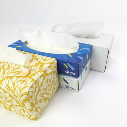 Linen rectangular tissue box cover with an off-white leaf design on a yellow background