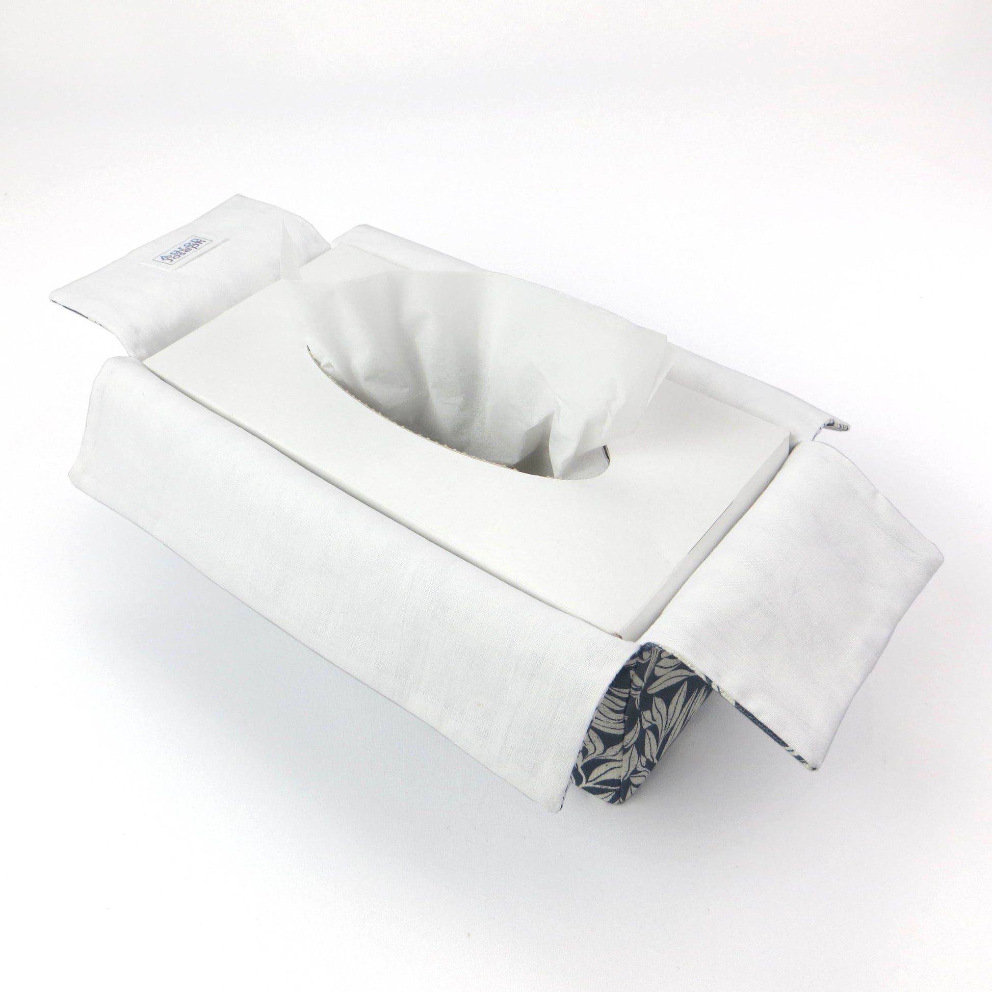 Linen rectangular tissue box cover with an off-white leaf pattern on a blue background