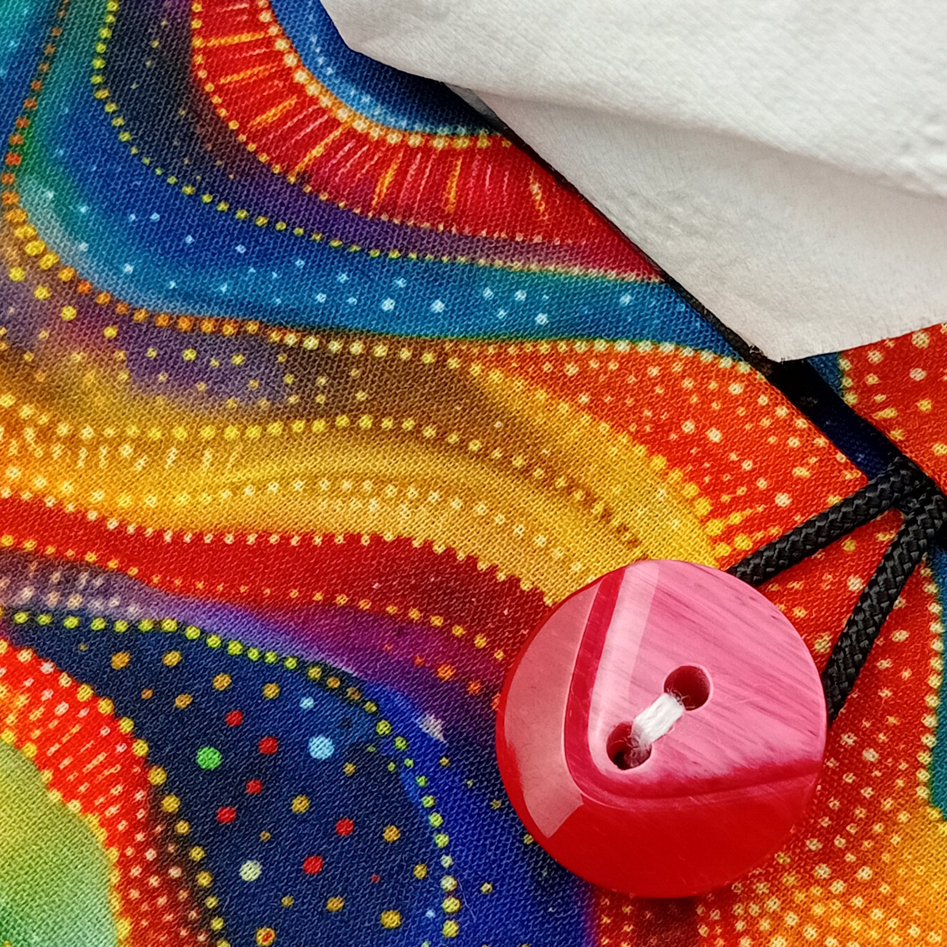 A close up view of a colourful wave patterned rectangular tissue box cover with buttons