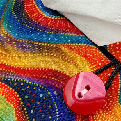 A close up view of a colourful wave patterned rectangular tissue box cover with buttons
