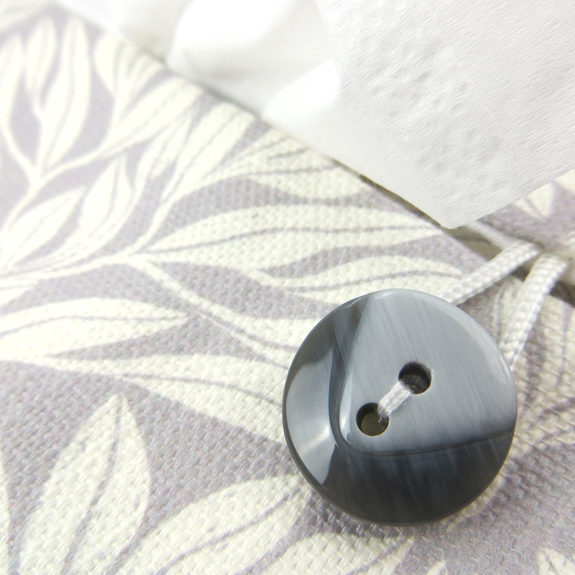 Linen rectangular tissue box cover with an off-white leaf pattern on a grey background