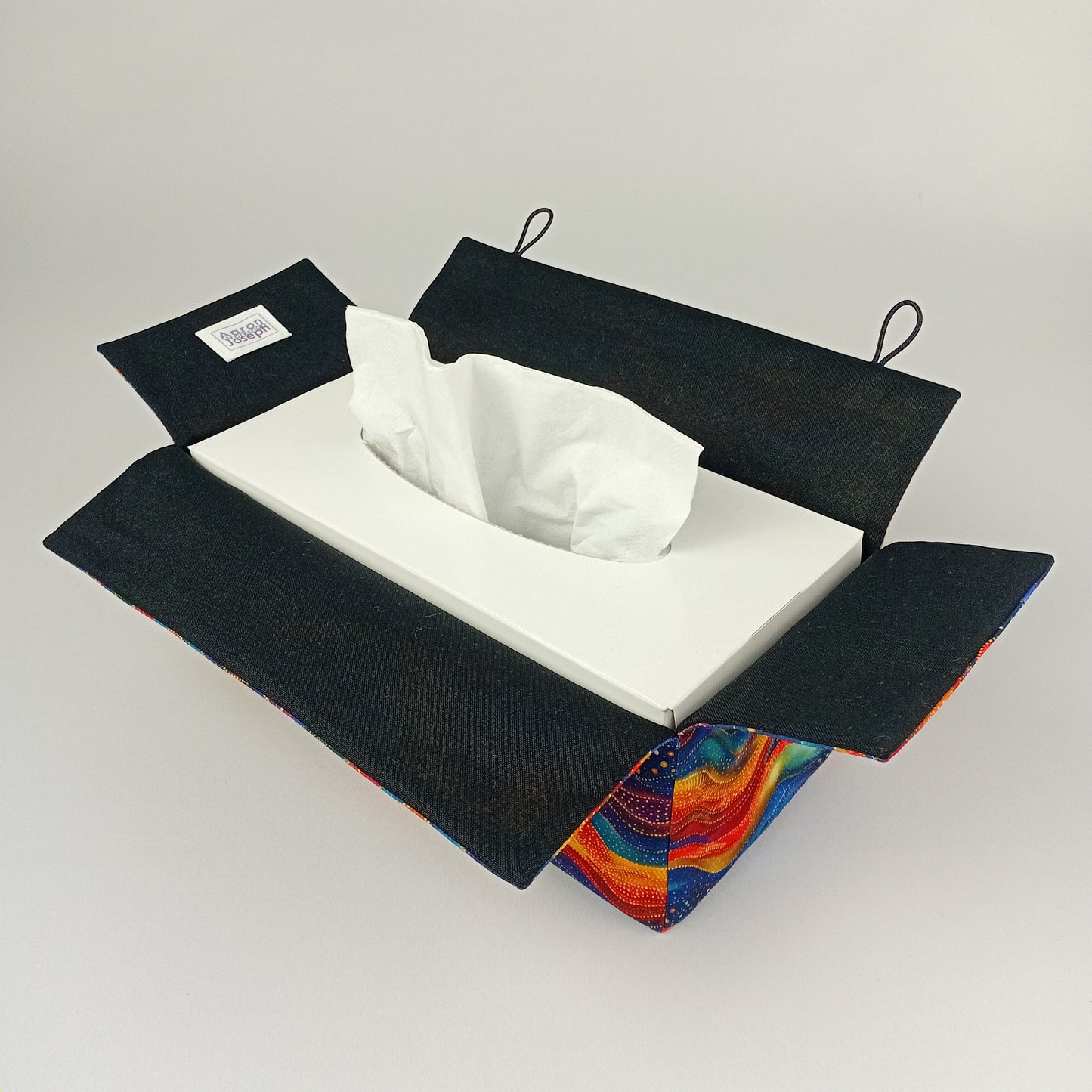 An interior view of a rectangular tissue box cover with black lining