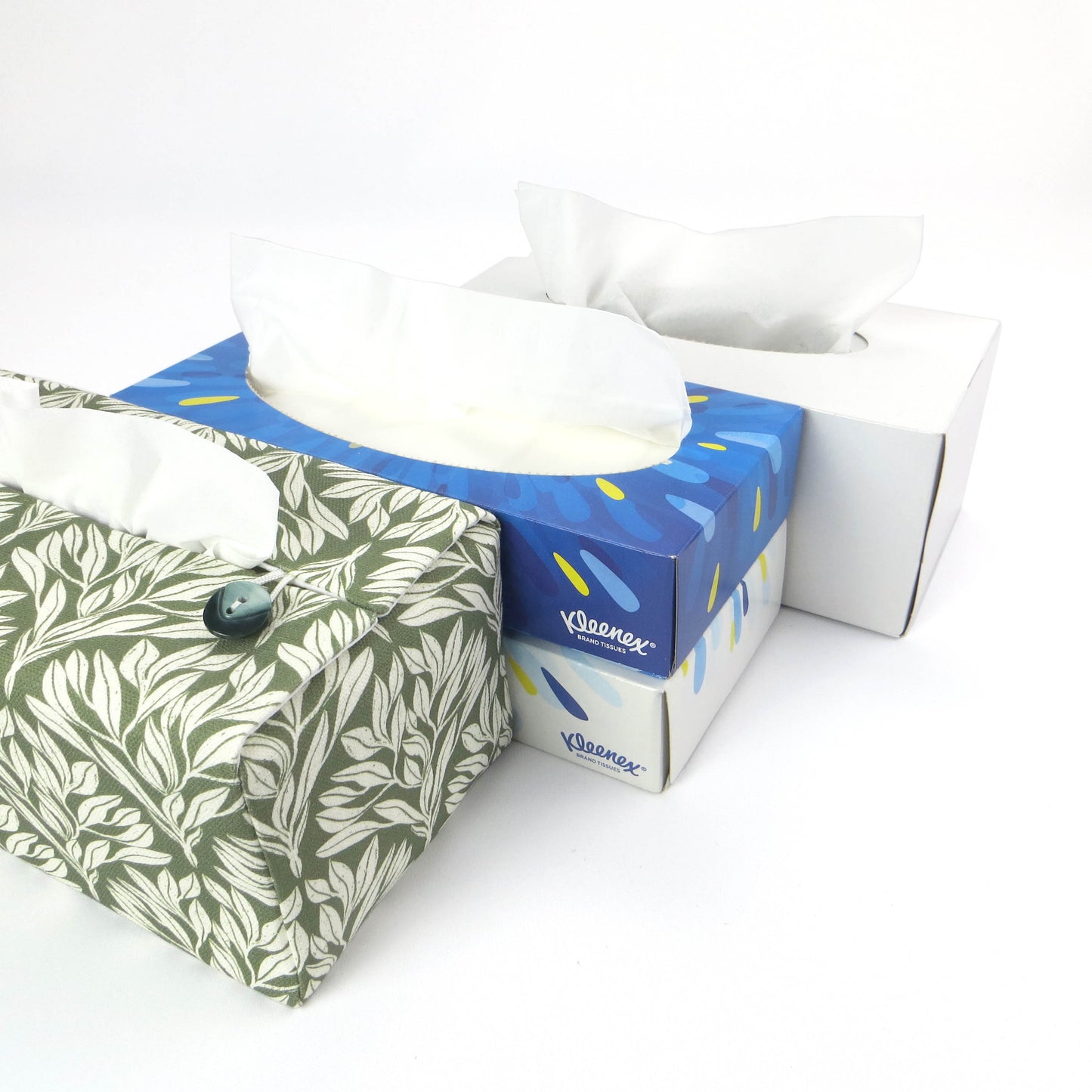 Linen rectangular tissue box cover with an off-white leaf pattern on a sage green background