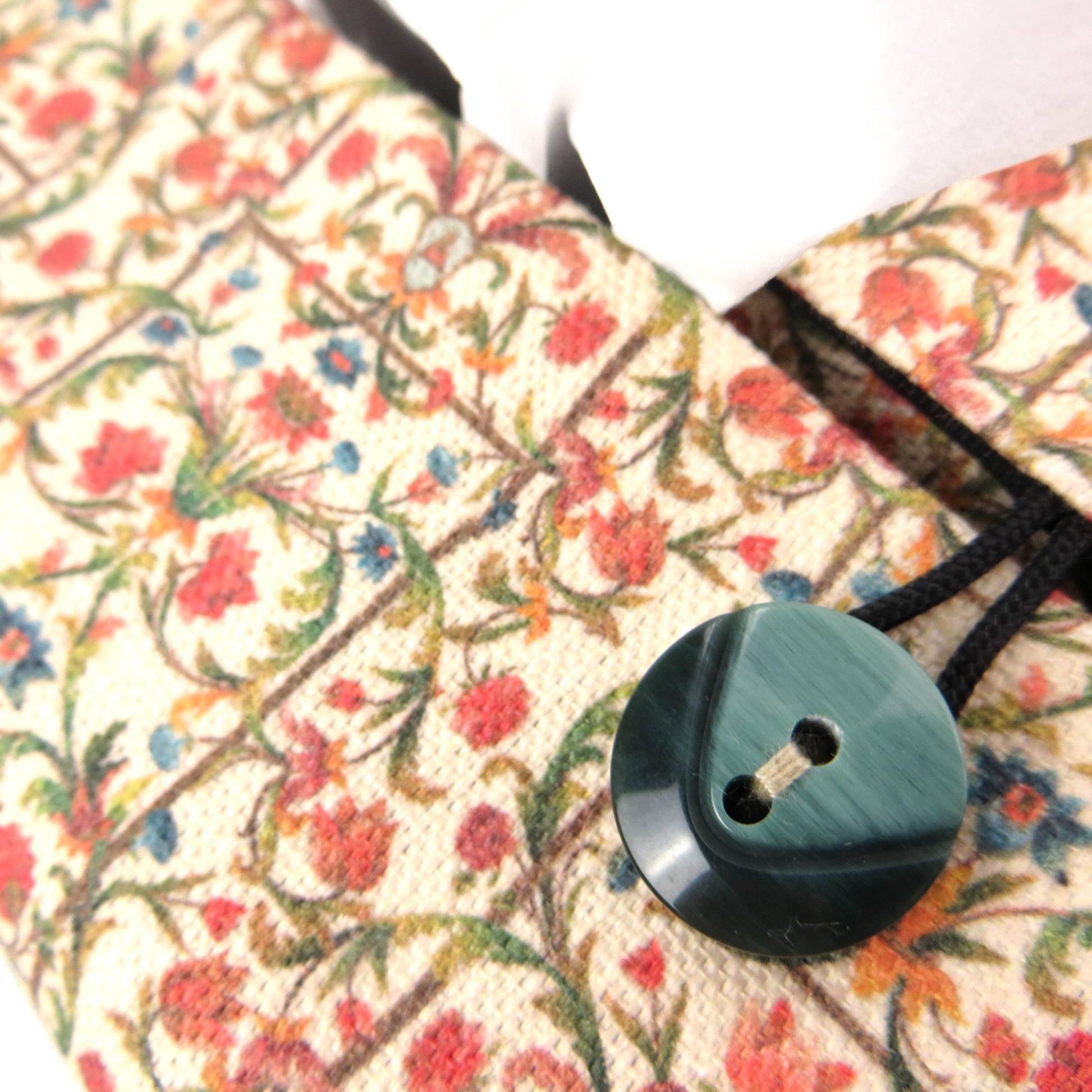 Linen rectangle tissue box cover with green vines with red and blue blossoms