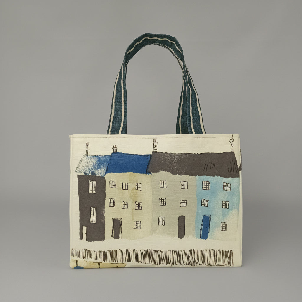 Front view of a handmade mini tote bag with seaside houses illustrated on an off-white background.