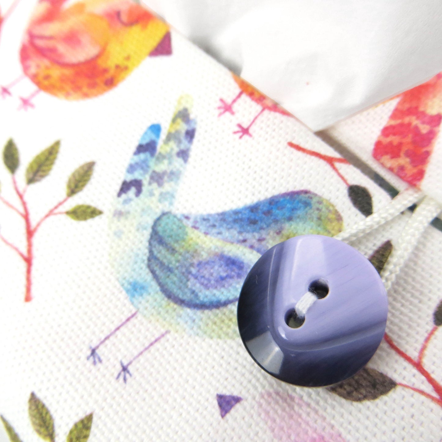 Cotton rectangle tissue box cover with watercolour style blue, purple, and orange sleeping birds on white background