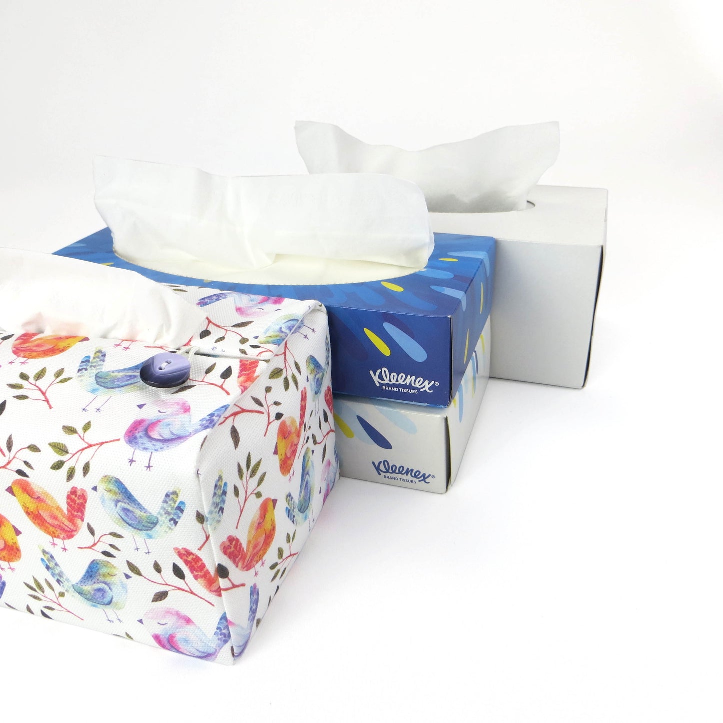 Cotton rectangle tissue box cover with watercolour style blue, purple, and orange sleeping birds on white background