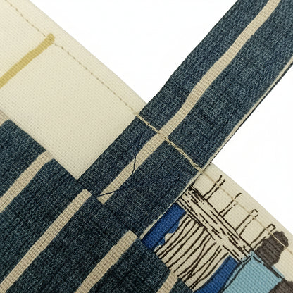 Close up view of a mini tote bag handle, interior, and exterior fabrics.
