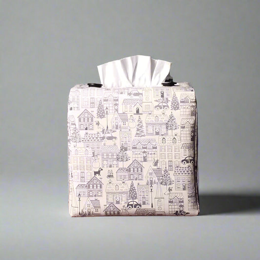Square tissue box cover  with holiday themed winter village scene on off-white background