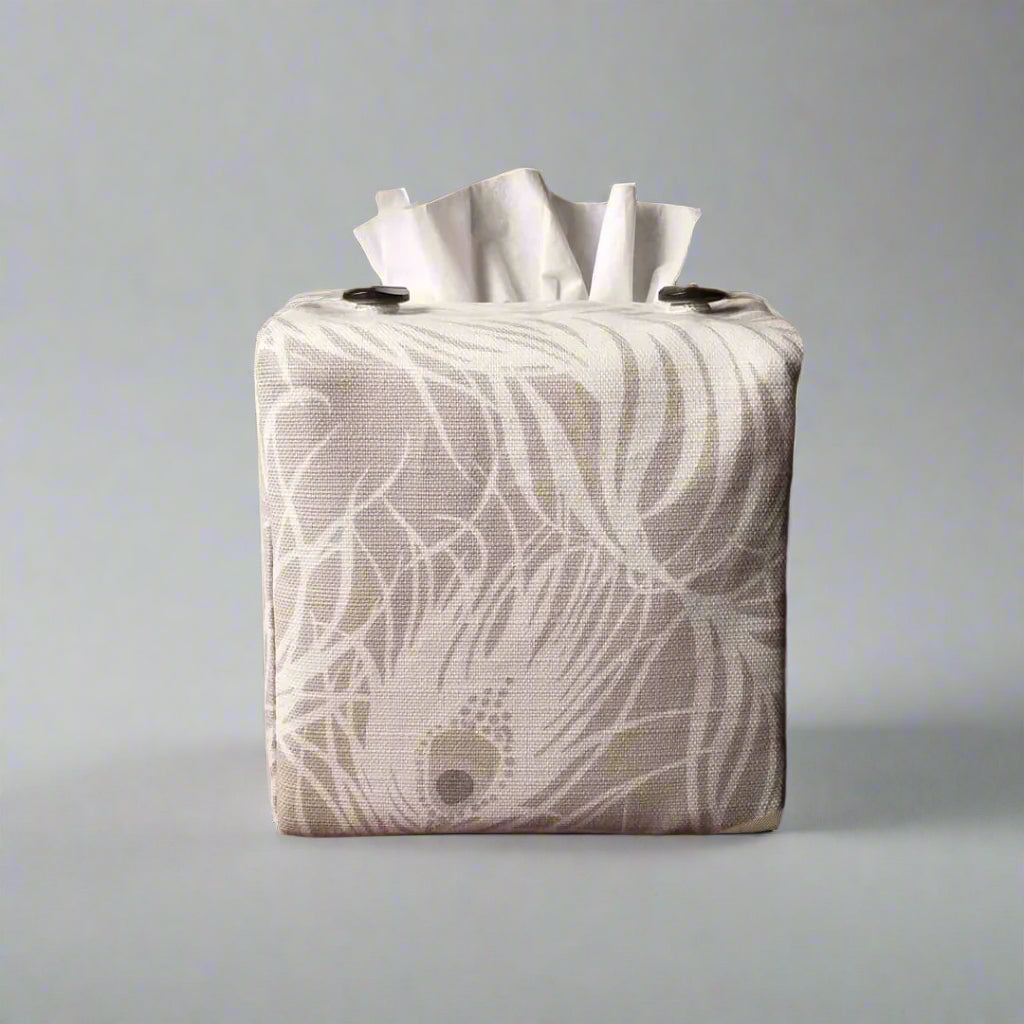 Square tissue box cover with white peacock feathers design on natural background