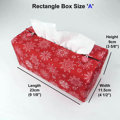 Rectangular tissue box cover with holiday themed white snowflake design on red background