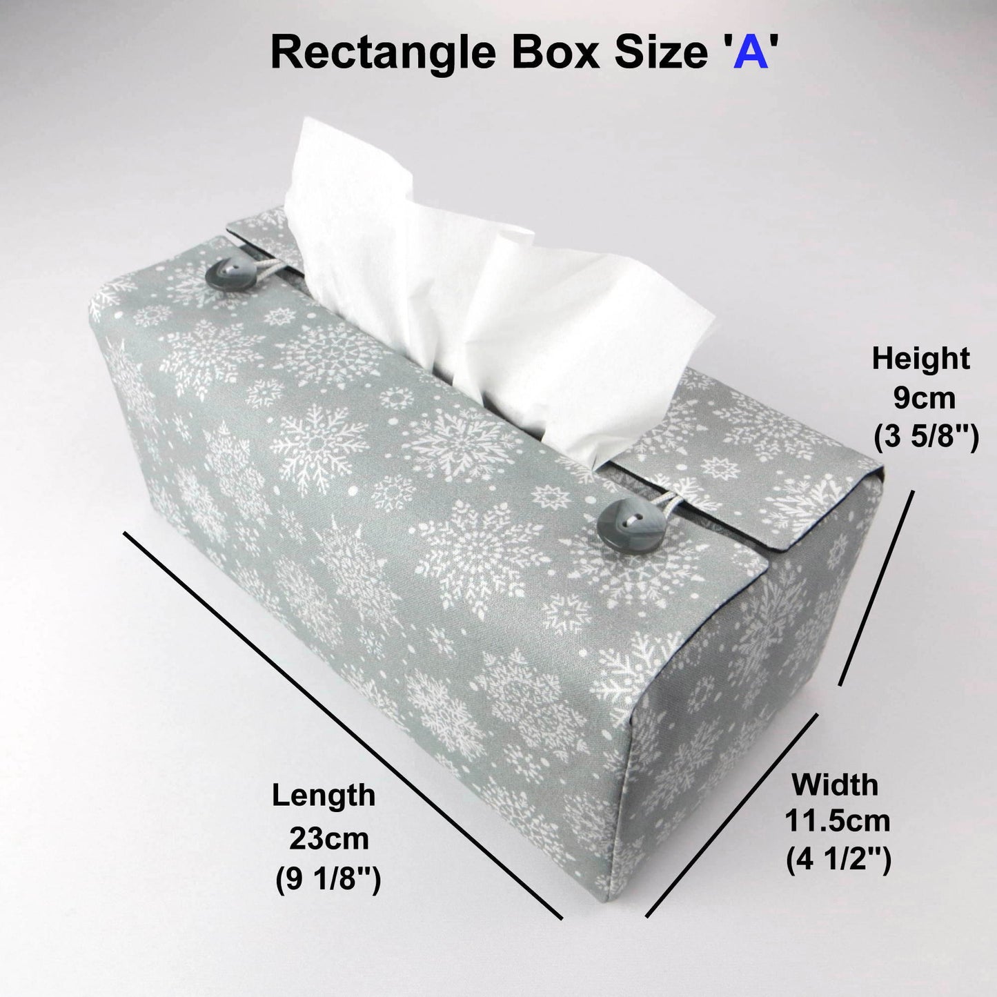 Rectangular tissue box cover with holiday themed white snowflake design on grey background