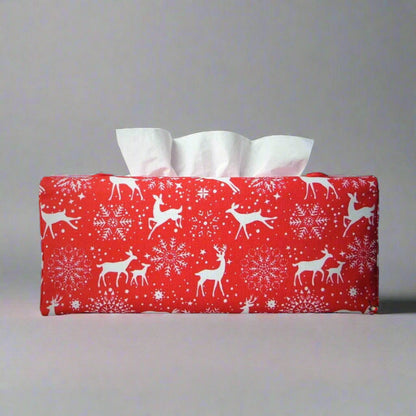 Rectangular tissue box cover with holiday themed white reindeer design on red background