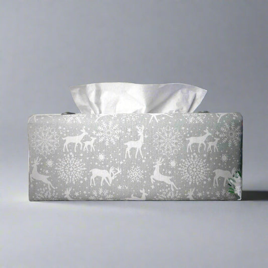 Rectangular tissue box cover with holiday themed white reindeer design on grey background