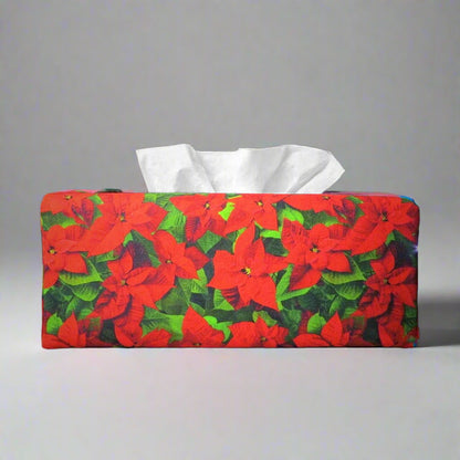 Rectangular tissue box cover with holiday themed poinsettia design on green leaf pattern background