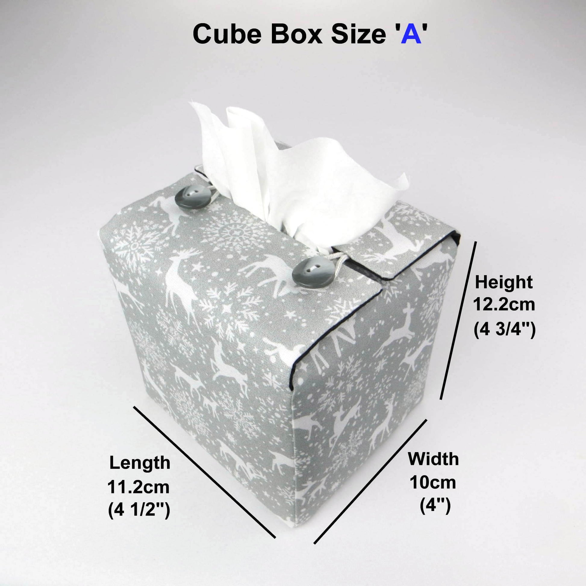 Square tissue box cover with holiday themed white reindeer design on grey background