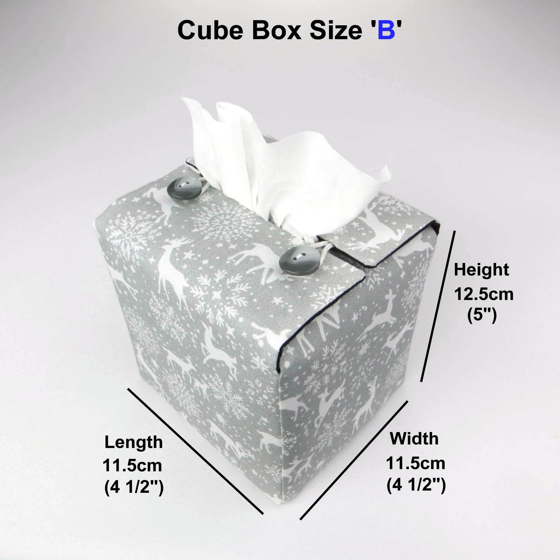 Square tissue box cover with holiday themed white reindeer design on grey background