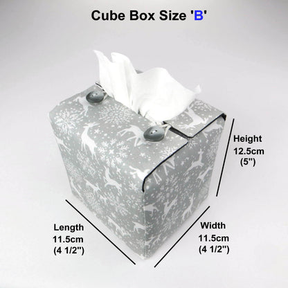 Square tissue box cover with holiday themed white reindeer design on grey background