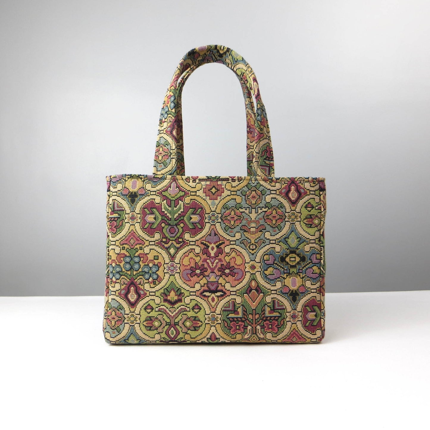 Mini tote bag with multi colour geometric pattern and purple velvet lining