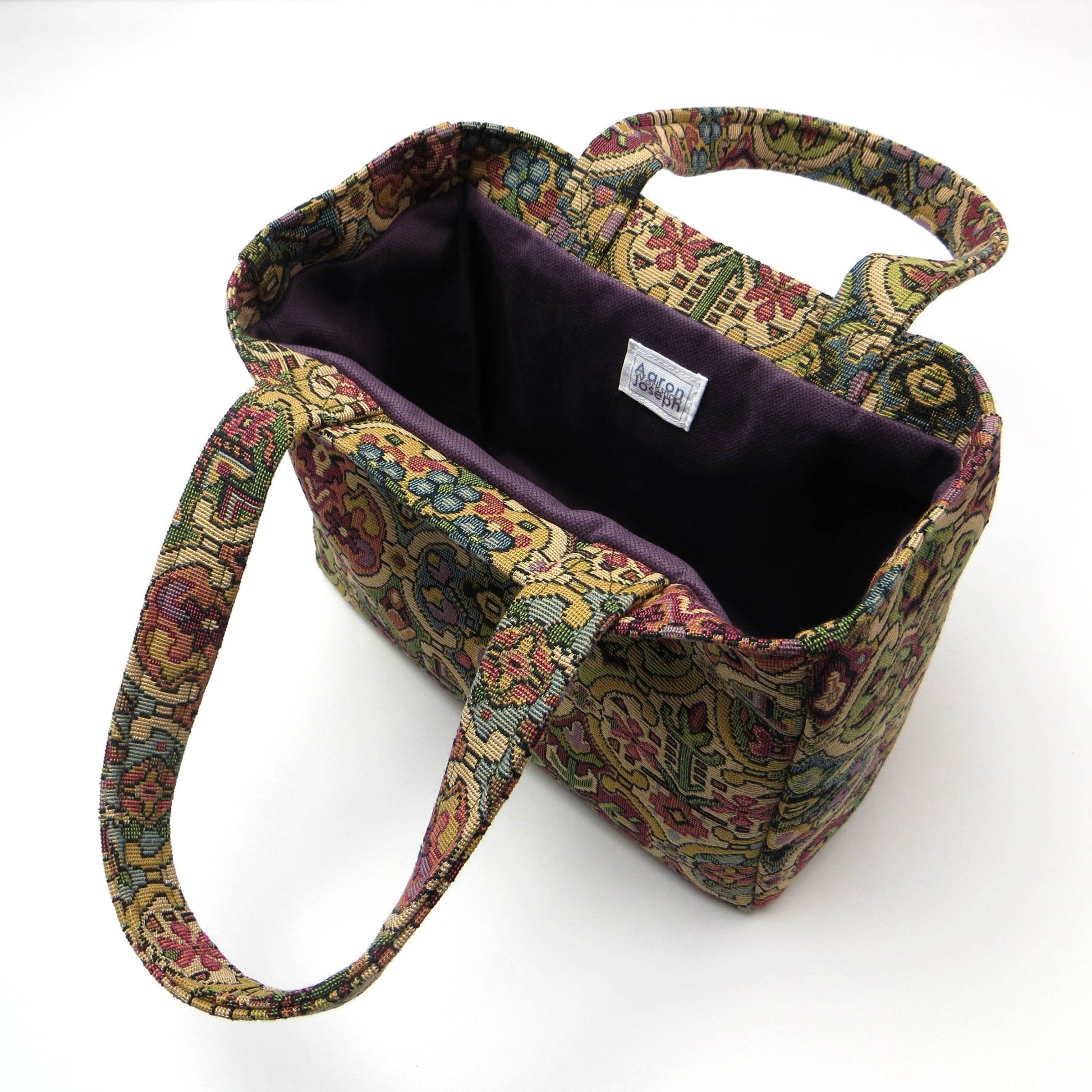 Mini tote bag with multi colour geometric pattern and purple velvet lining