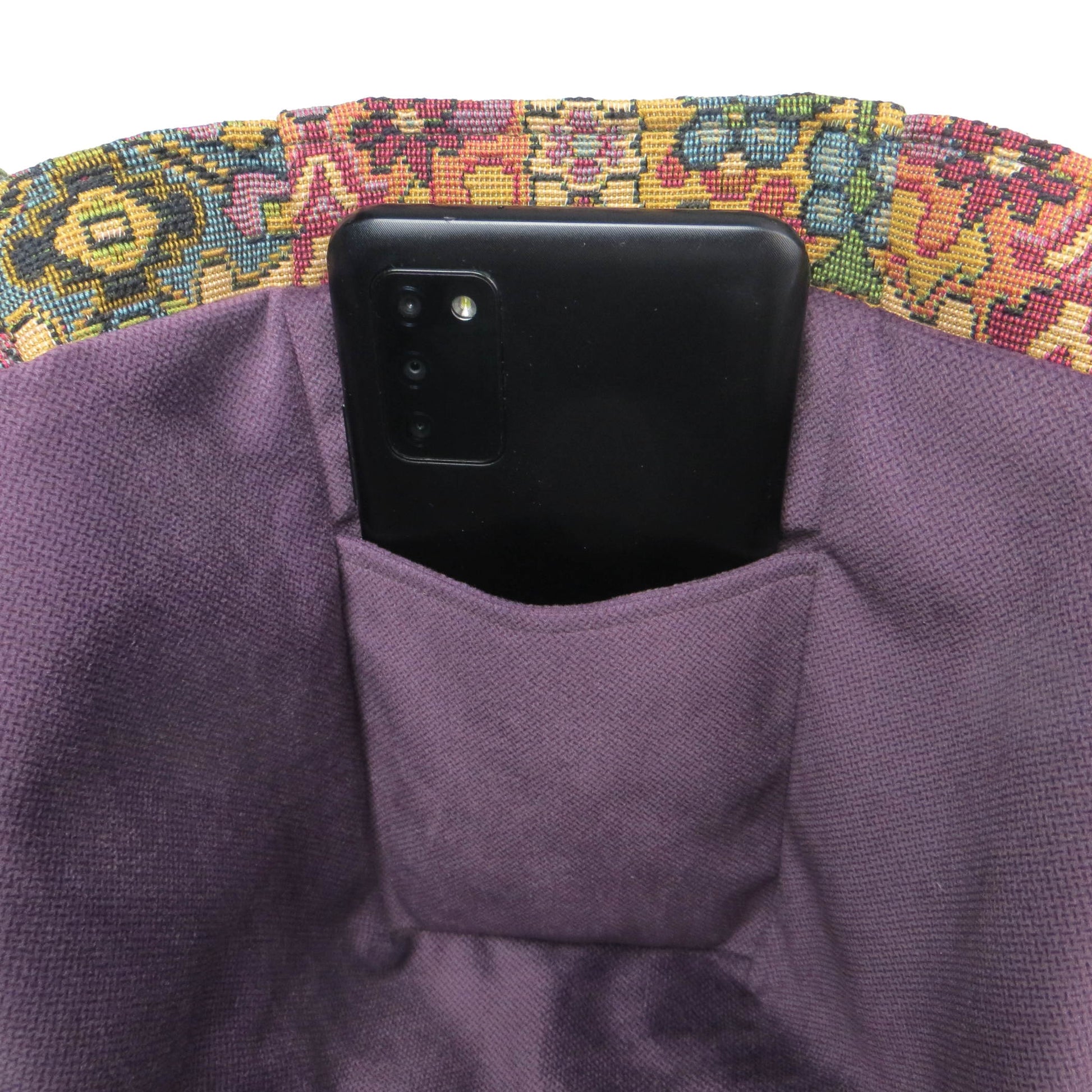 Mini tote bag with multi colour geometric pattern and purple velvet lining