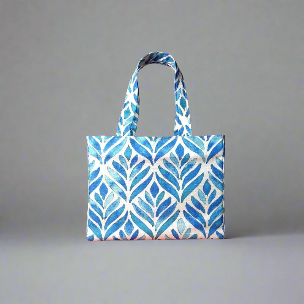 Mini tote bag with blue watercolour style leaf pattern on background