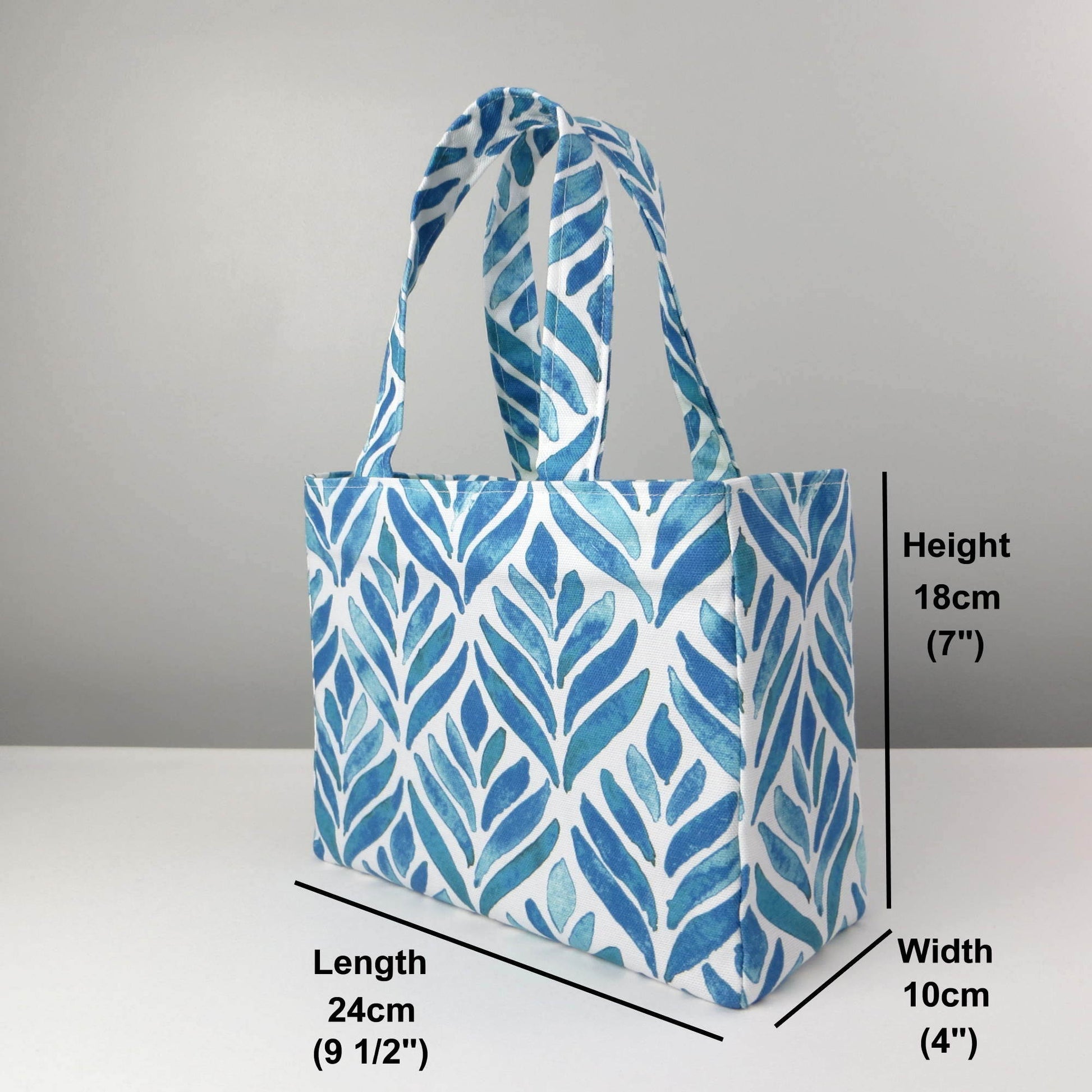 Mini tote bag with blue watercolour style leaf pattern on background