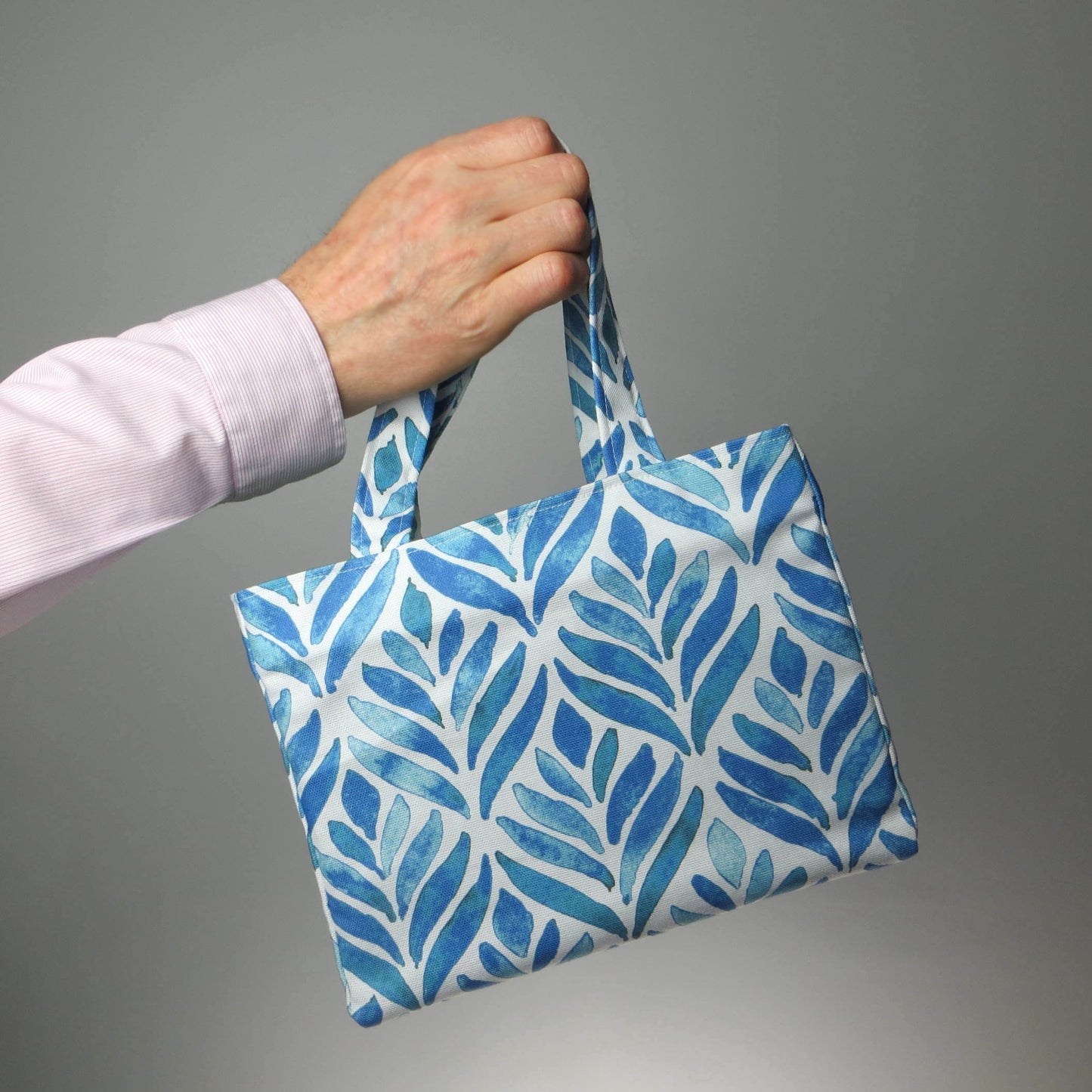 Mini tote bag with blue watercolour style leaf pattern on background