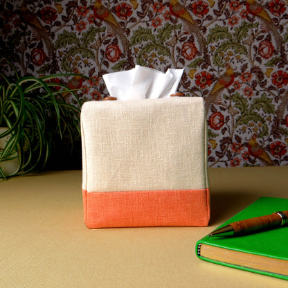 Square tissue box cover with a pen, notebook, and plant