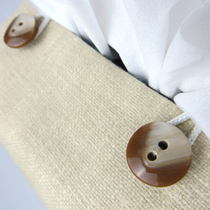 Close up view of square tissue box cover with buttons