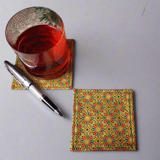 Square coasters with holiday themed blue, red, and green petals, with metallic gold accent