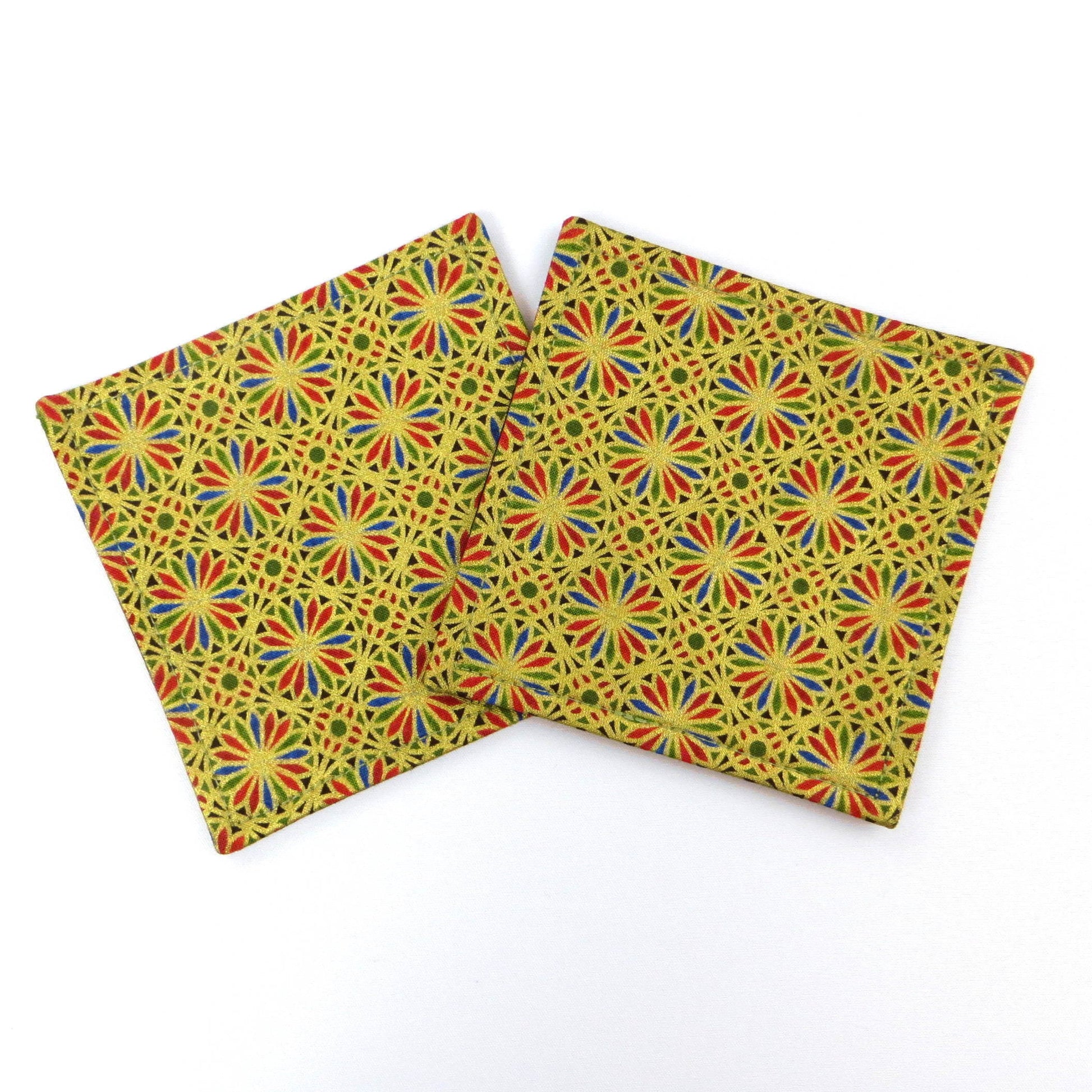 Square coasters with holiday themed blue, red, and green petals, with metallic gold accent