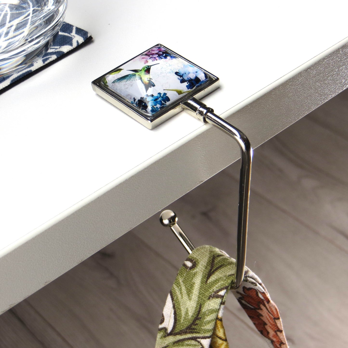 Handbag hook hanging on a table