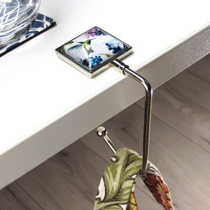 Handbag hook hanging on a table