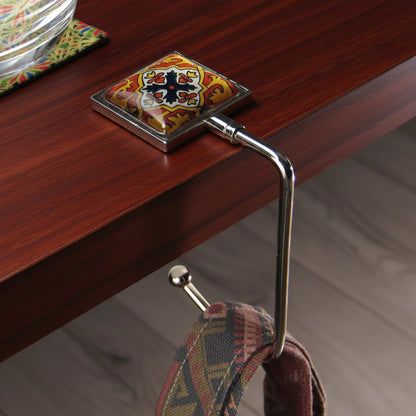Handbag hook hanging on a table