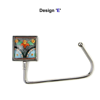 Handbag hook with a glass domed blue, black, and orange graphic design image