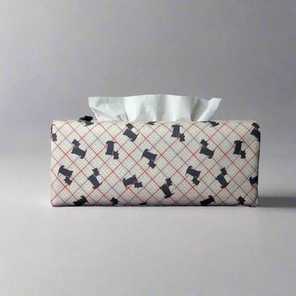 Rectangle tissue box cover with iconic black Scottish Terrier dogs with metallic gold collar design on beige background with red, purple, and white grid