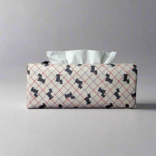Rectangle tissue box cover with iconic black Scottish Terrier dogs with metallic gold collar design on beige background with red, purple, and white grid