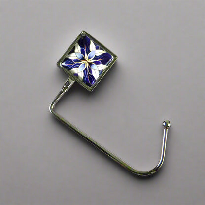 Handbag hook with glass domed image for hanging accessories on tables, ledges, and shelves