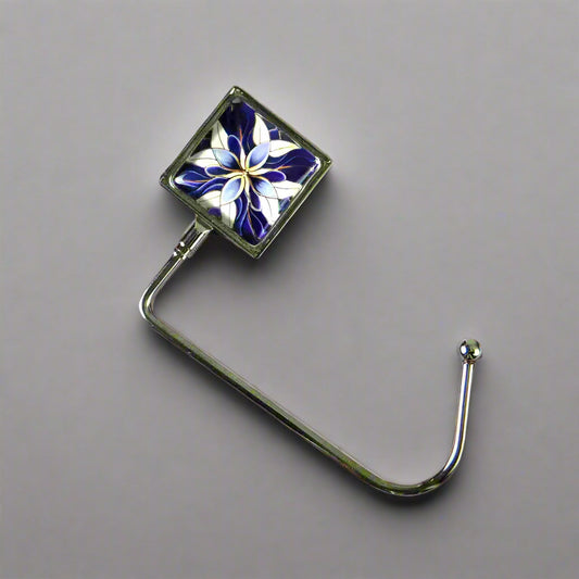 Handbag hook with glass domed image for hanging accessories on tables, ledges, and shelves