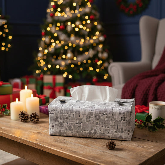 Tissue box cover with a black and white winter village scene displayed in a bathroom and living room