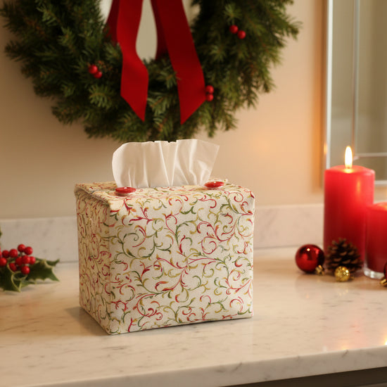Tissue box cover with red and green swirl design displayed in a bathroom and living room