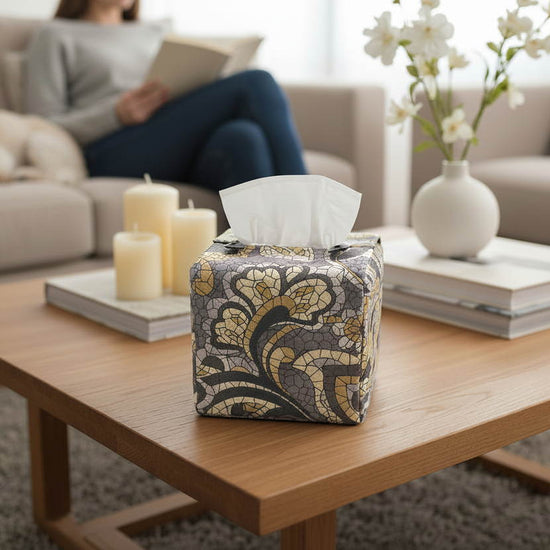Handmade tissue box cover with grey paisley design displayed in a living room