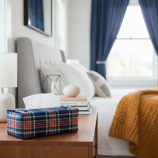 Handmade cotton rectangular tissue box cover with a navy and orange plaid design displayed in a bedroom