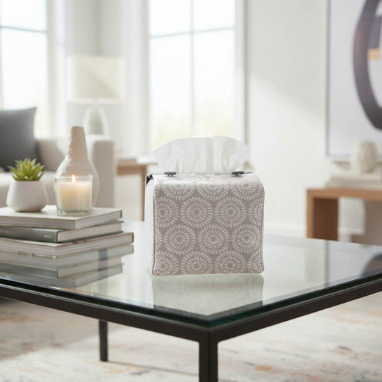 Handmade tissue box cover with retro daisy design displayed in a living room